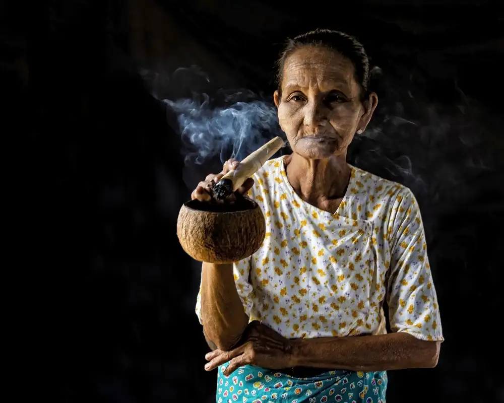 Golani, Aharon: Woman smokes cigar, Bagan, Myanmar