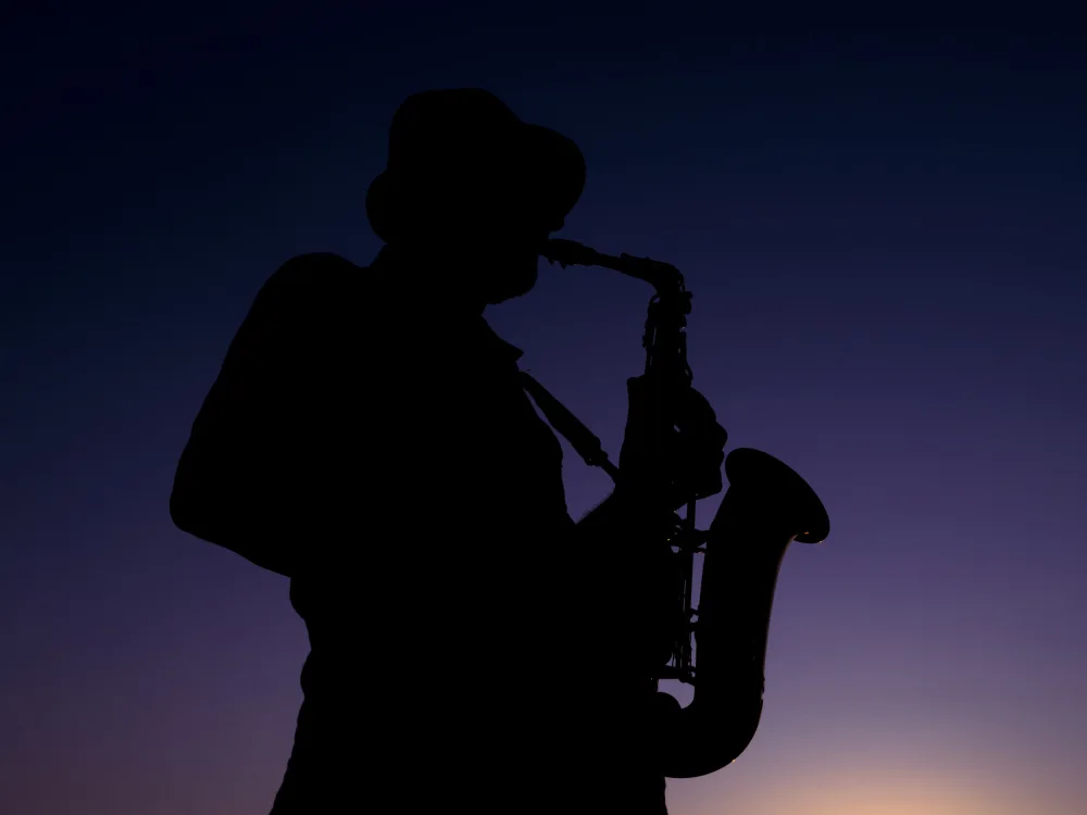 akyurt, engin: a musician playing the saxophone at sunset