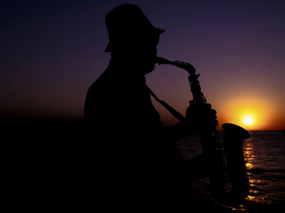 akyurt, engin: a musician playing the saxophone at sunset