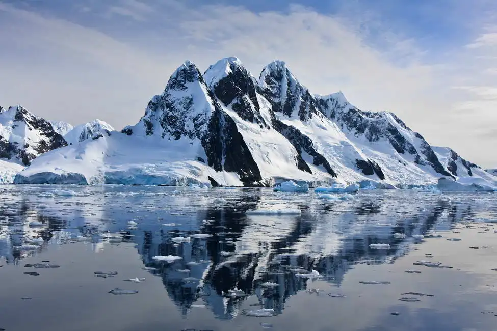 Unknown: Snowy mountains against a blue sky in Antarctica